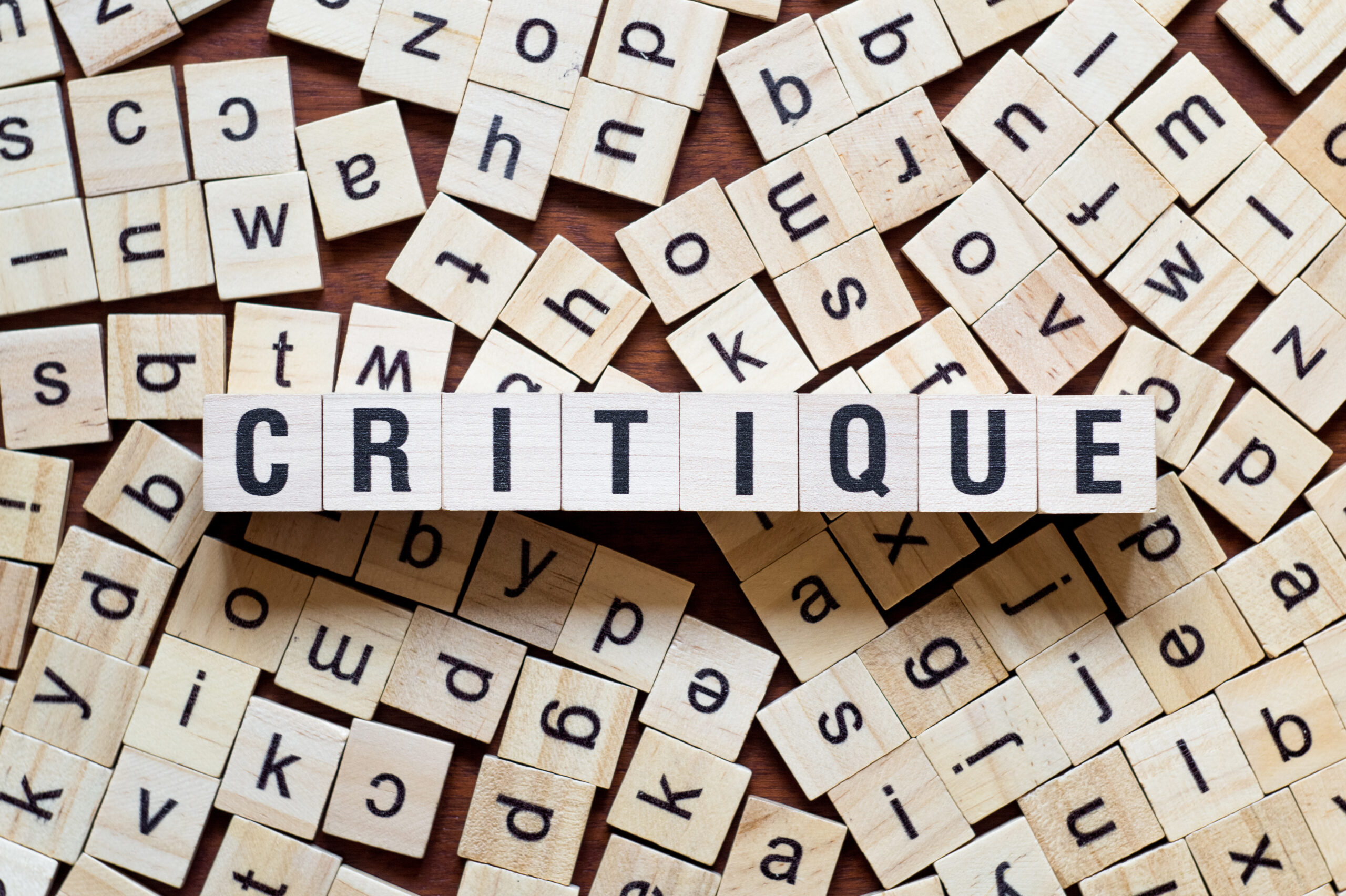 Critique spelled out in Scrabble tiles
